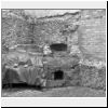 bricked up medieval window sandwiched between two more recent windows