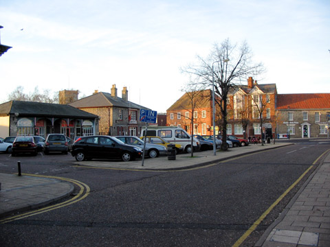 The historic, paved Market Place in Thetford, surrounded by traditional brick buildings