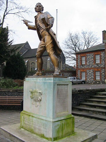 The gilded bronze statue of Thomas Paine holding his book 'Rights of Man' outside the council offices in Thetford, Norfolk