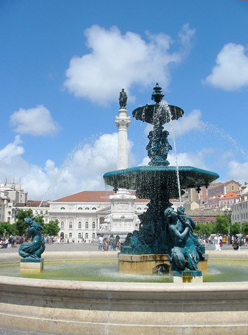 A sweeping view across an expansive, sunlit public praça or square in the heart of Lisbon