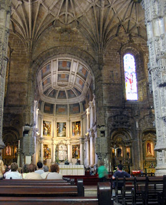 The soaring, intricately carved stone pillars and vaulted ceiling inside the church of the Jerónimos Monastery