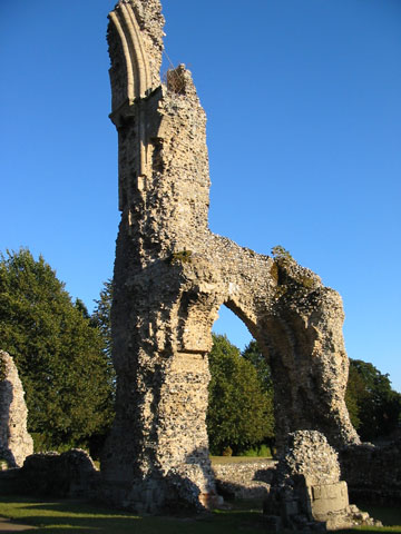 The stark, roofless standing walls of the Church of St Mary at the ruins of Thetford Priory
